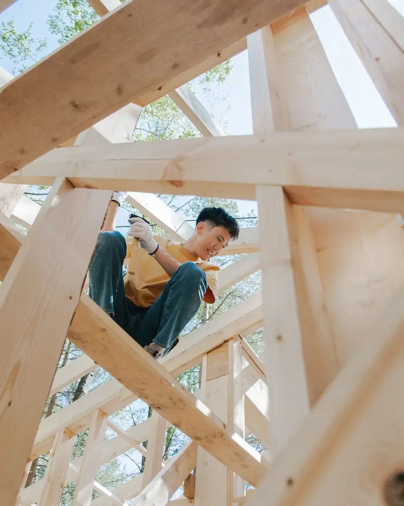 Worker on a ladder inside new framing
