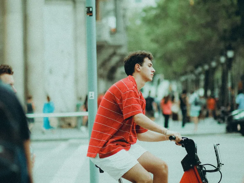 Young man riding an electric bike in the city