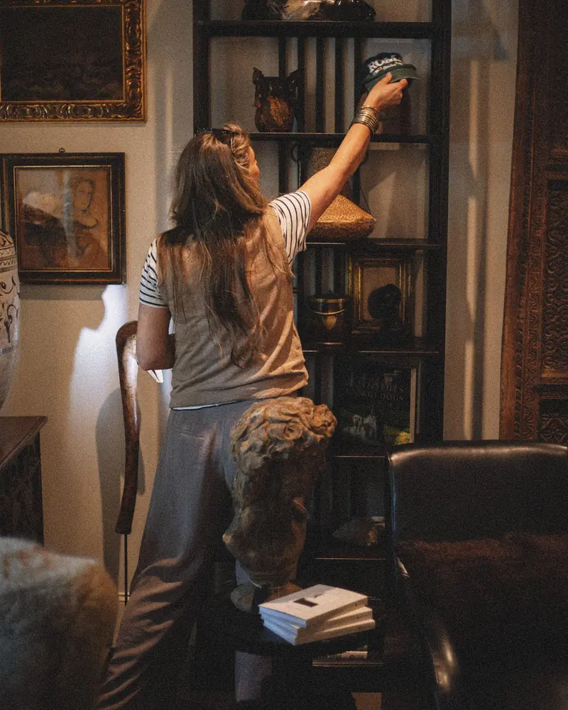Shop owner arranging shelves in a boutique